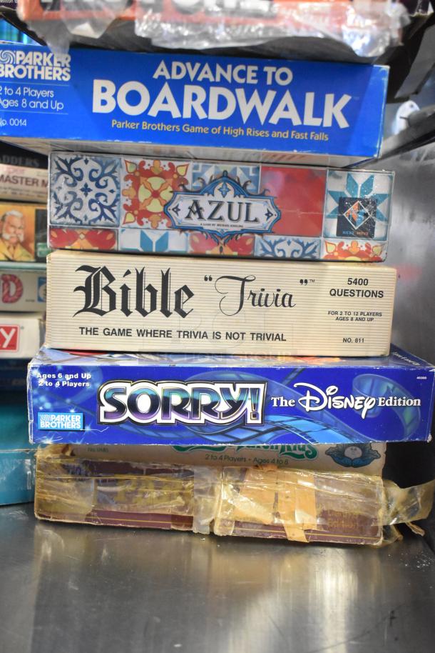 Tiered lot of board games including "Advance to Boardwalk," "Azul," "Bible Trivia," and "Sorry! The Disney Edition." Fair condition.