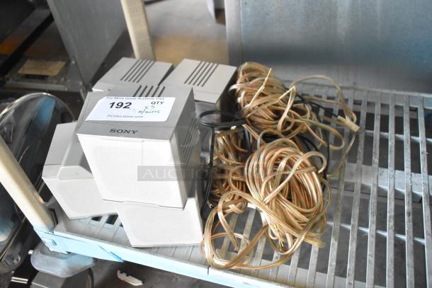 5 Sony SS-TS502 speakers with wires, gently used. Auction label indicates quantity and auction site details.