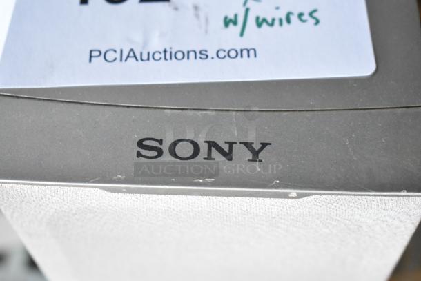 5 Sony SS-TS502 speakers, gray finish, includes wires, PCI Auctions label visible. Good condition.