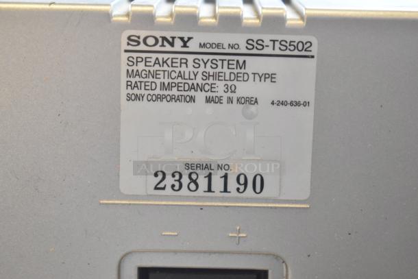 Close-up of a Sony SS-TS502 speaker label showing model, impedance of 3Ω, and serial number 2381190. Made in Korea.