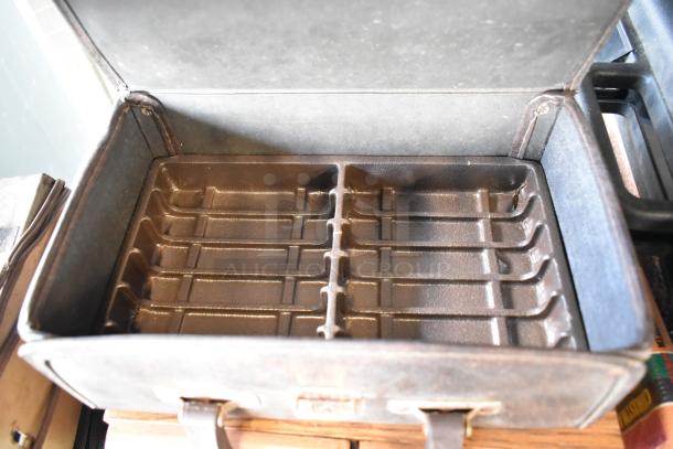 Open Marsand bag with divided interior, brown leather exterior, showing signs of wear and age.