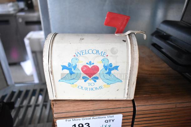 Vintage decorative mailbox with a "Welcome to Our Home" design featuring ducks, a red flag, showing light wear.