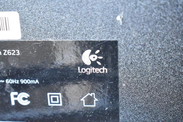 Close-up of a Logitech label on a multimedia device, model Z623. Indicates power specs of ~60Hz 900mA.