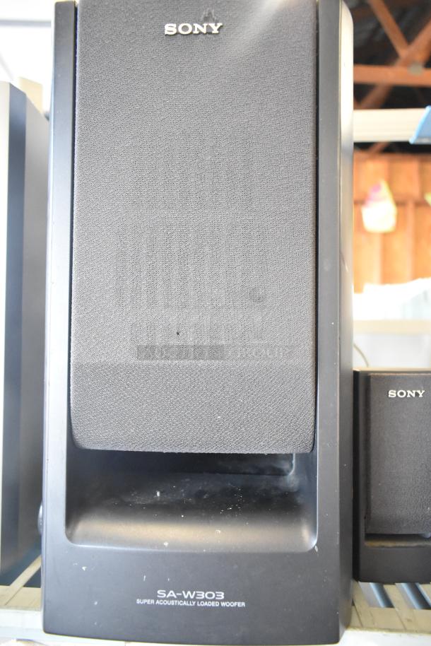Sony SA-W303 speaker with black mesh front. Label reads "Super Acoustically Loaded Woofer." Good condition.