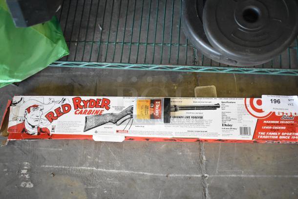 Red Ryder BB Gun in original packaging, comes with Daisy BBs. Includes weight plates. Appears in good condition.