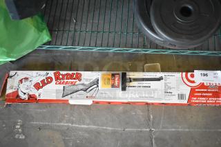 Red Ryder BB Gun in original packaging, comes with Daisy BBs. Includes weight plates. Appears in good condition.