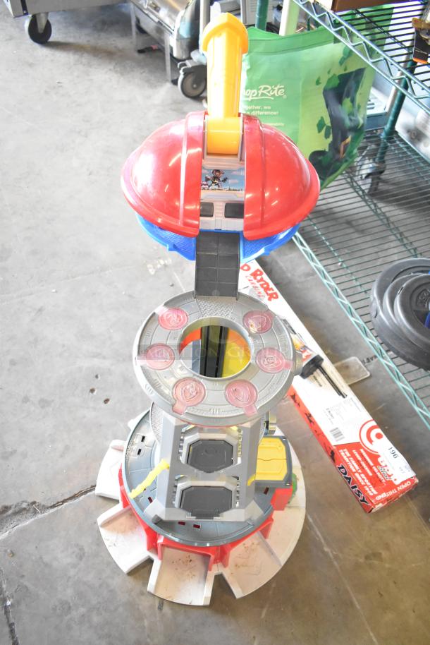 Two-tier lot with assorted items, featuring fishing lures, windchimes, and a Nintendo Switch controller holder.