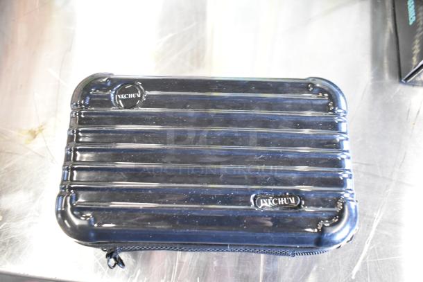 Ribbed black case with "YACHUV" logo, part of a two-tier lot including fishing lures, windchimes, and a Nintendo Switch controller holder.