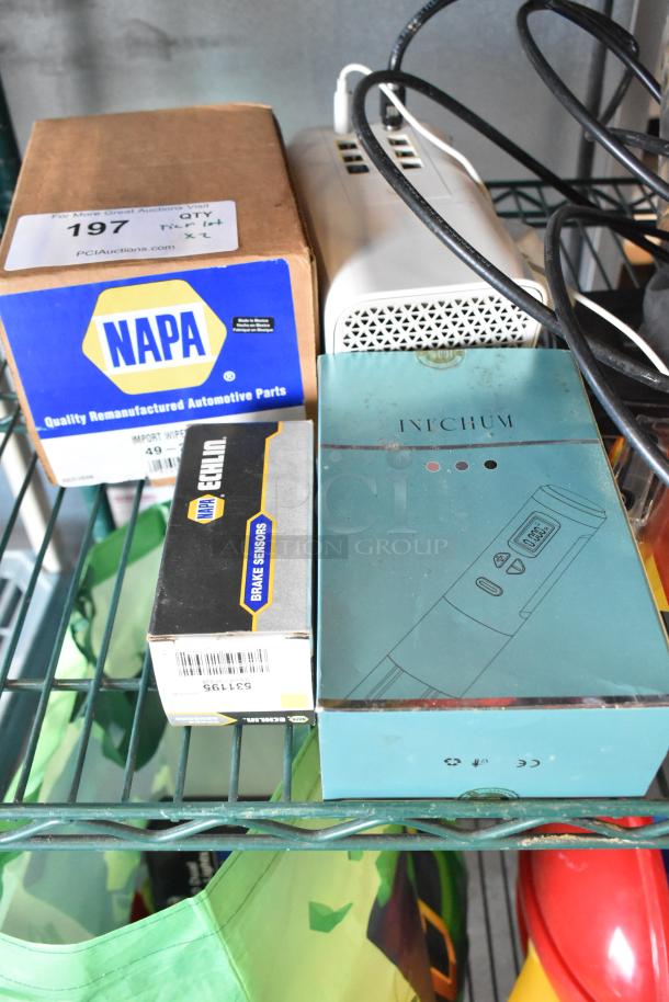 A two-tier lot featuring a variety of items including NAPA brake sensors box, Invchum device, wires, and household items.