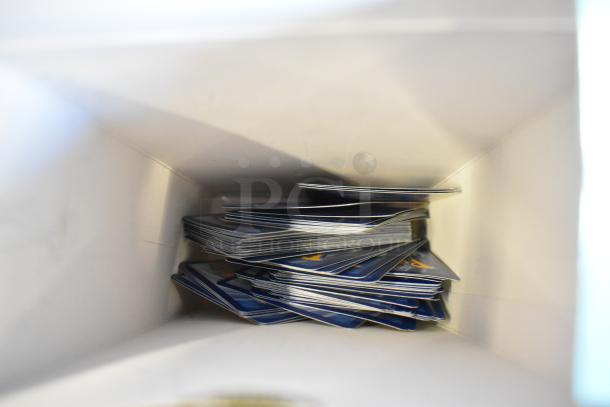 Two-tier lot items include fishing lures, windchimes, and a Nintendo Switch controller holder. Cards stacked inside a box.