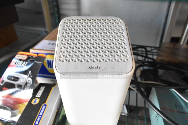 Two-tier lot featuring fishing lures, windchimes, Nintendo Switch controller holder, and an Xfinity device.