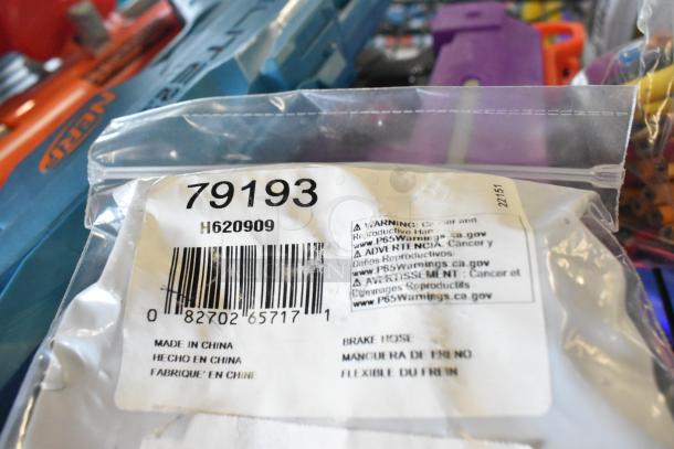 Two-tier lot with various items, including toy guns. Visible label reads "79193" with warnings and barcode. Made in China.