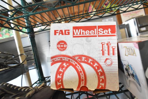 Two-tier lot with various items including a FAG Wheel Set box and a Zelda-themed item, showcasing packaging and condition.