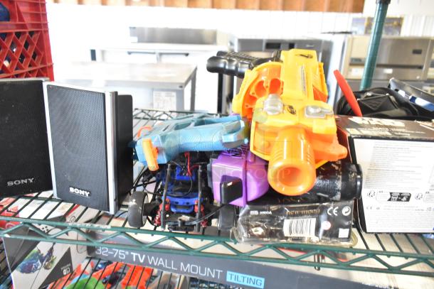 Two-tier lot featuring a Sony speaker, toy blaster, Jacob doll, and Star Wars Darth Vader toy, in used condition.