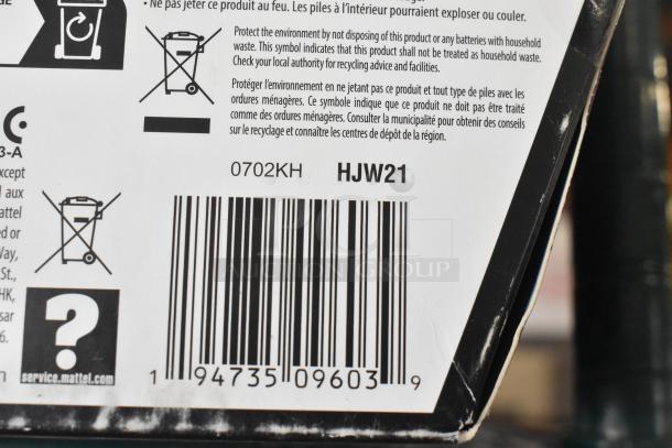 Barcode and recycling symbol on a Mattel packaging, marked 0702KH HJW21.