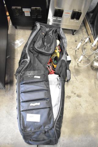 BagBoy bag with jump rope and shoes inside, black exterior, visible tag with "201," in good used condition.