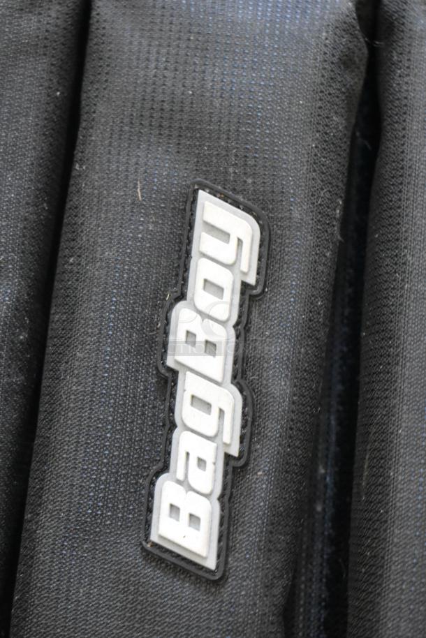 BagBoy bag displaying logo, black fabric, includes jump rope, shoes. Visible wear suggests moderate use.