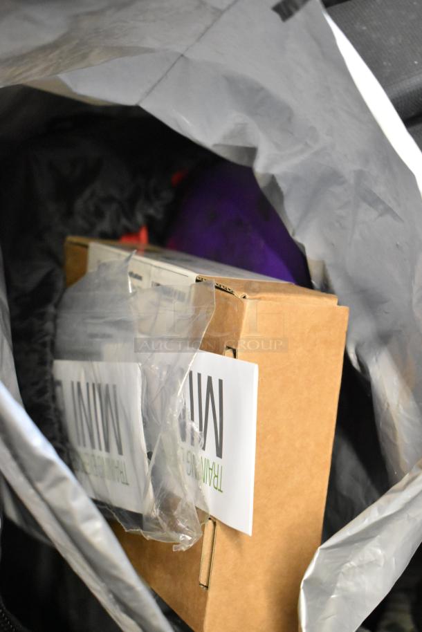 BagBoy bag contains a jump rope, shoes in box, and miscellaneous items. Bag visibly worn; contents appear new.