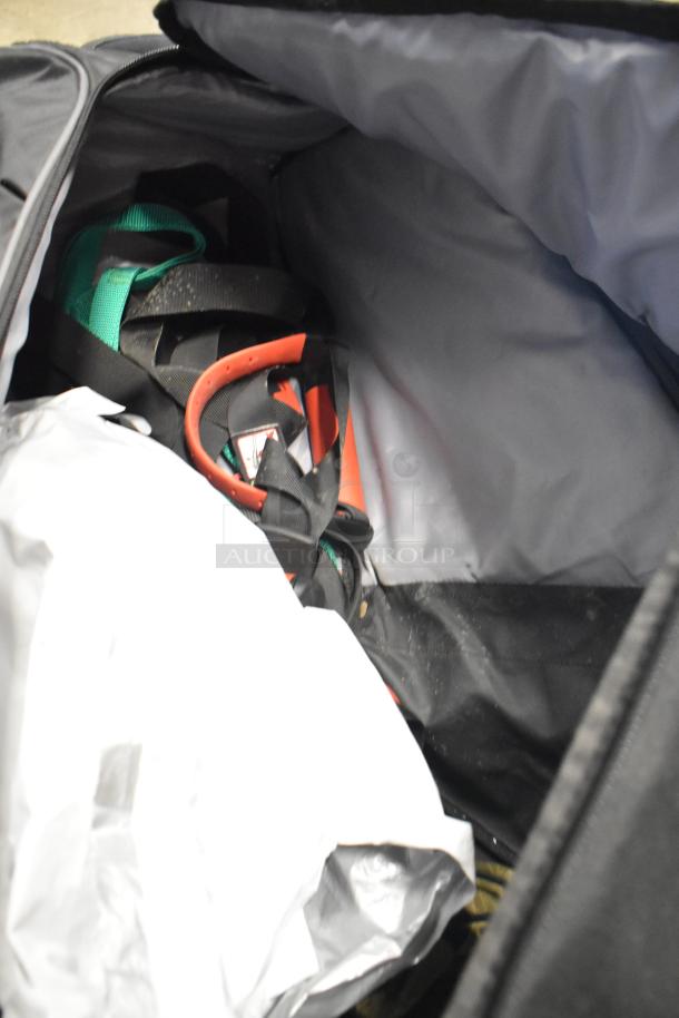 BagBoy bag containing a jump rope and shoes. The bag is open showing assorted contents. Condition appears used.