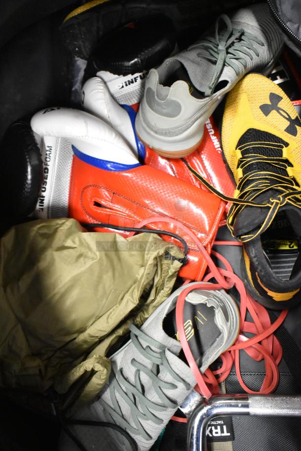 BagBoy bag containing gym gear including gray and yellow shoes, a red jump rope, and boxing gloves. Well-used condition.
