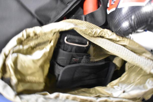 BagBoy bag with visible contents including a jump rope, shoes, and a boxing glove. Interior shows netting and straps.