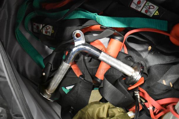 BagBoy bag filled with contents including a jump rope and shoes. Mix of straps and metal items visible. Appears gently used.