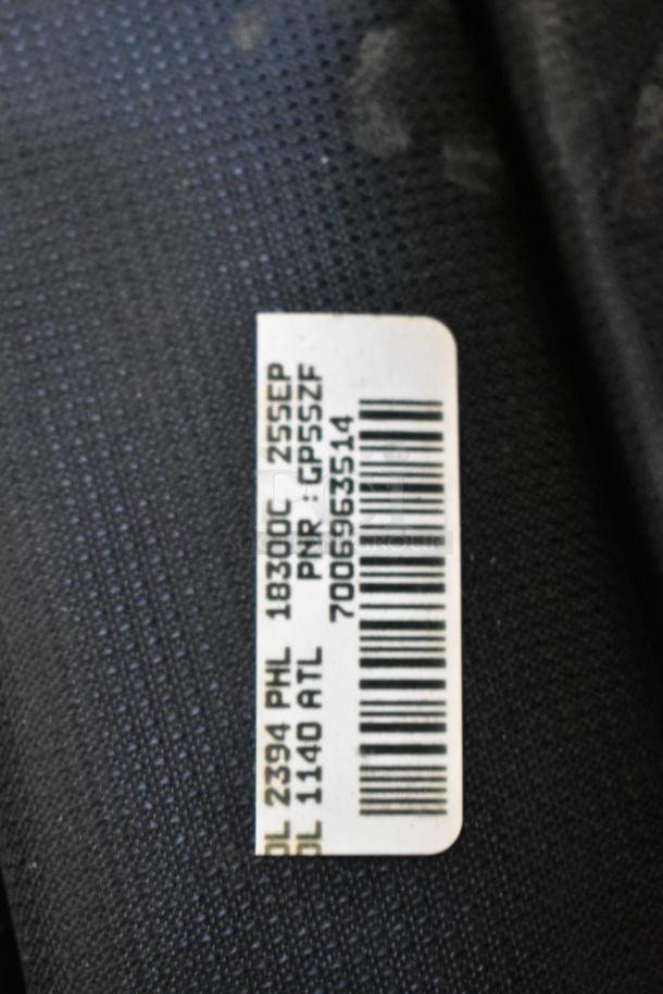 BagBoy bag with attached tag showing barcodes and travel details. Includes jump rope and shoes. Condition not specified.