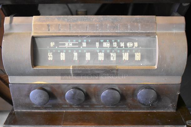 Victrola wood pattern counter with record player; features RCA Victor tuner display and four control knobs in vintage condition.