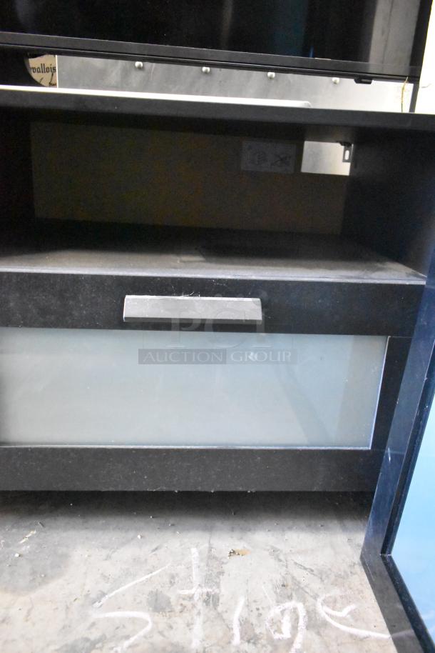 Samsung TV with black stand, glass front panel and metal handle. Buyer pickup only. Sold as two items per bid.