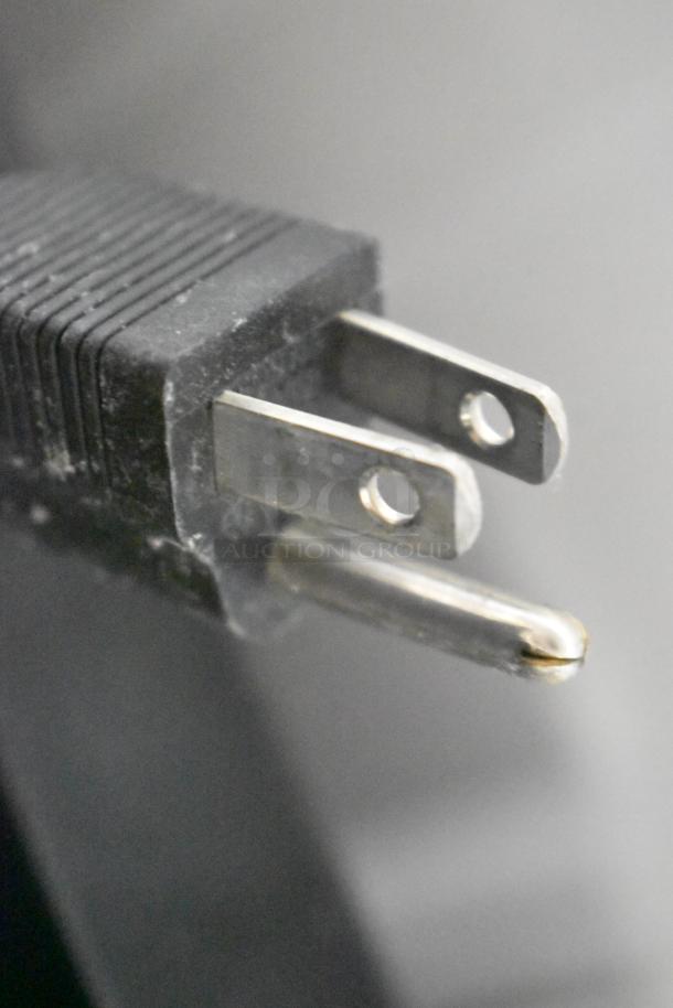 Close-up of a power plug for a Samsung PN50A400C2DXZA 50" TV. Plug shows minor wear, indicating previous use.