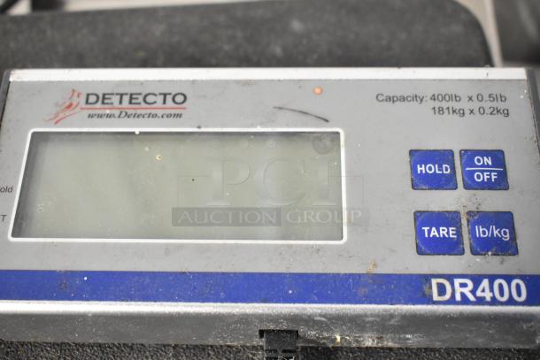 Detecto DR400 scale, 400 lb capacity, visible markings include brand logo and weight units, slightly worn condition.