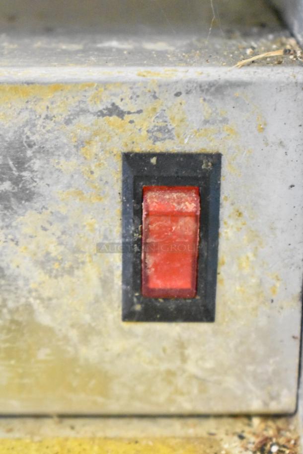 Win-holt WHSS-1 metal film wrapper machine with visible wear. Features red switch, 120 volts, 1 phase.