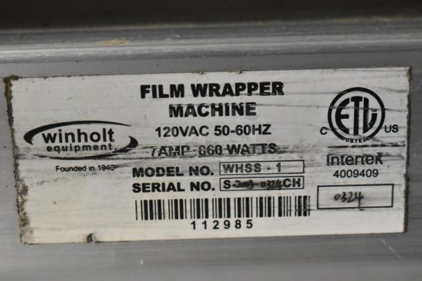 Win-holt WHSS-1 film wrapper machine with label. Features 120VAC, 50-60Hz, 7 amp, 860 watts. Model WHSS-1.