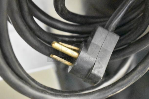 Close-up of a power cord plug associated with the 2022 Delfield 406P-STAR4 undercounter cooler.
