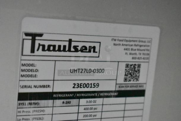 Label on Traulsen UHT27L0-0300 undercounter cooler showing model, serial number 23E00159, and refrigerant details.