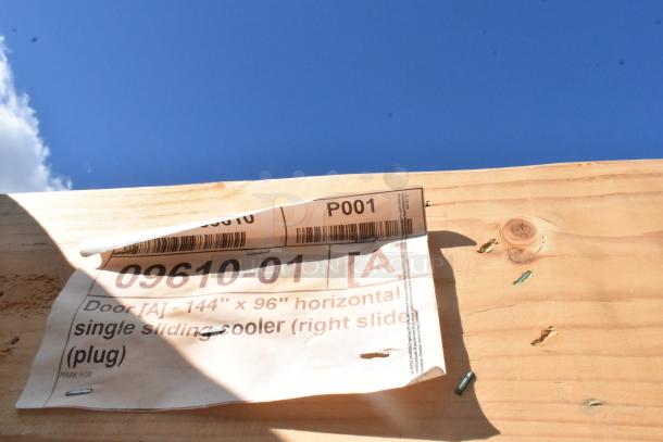 Brand new scratch and dent door, 144"x96", single sliding cooler, right slide. Label shows model number 09610-01.