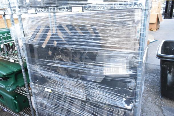 Chrome finish 4-tier wire shelving unit with contents, wrapped in plastic. Buyer must dismantle; consider freight charges.