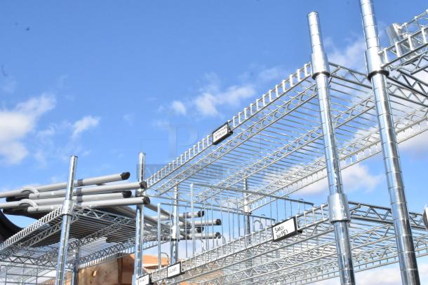 Chrome finish 6-tier wire shelving unit with various contents, including green poly insulated beverage dispensers. Buyer to dismantle.