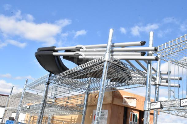 Chrome finish 4 tier wire shelving unit with folding chairs on top. Includes contents; buyer must dismantle.