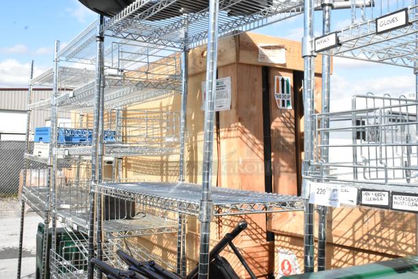 Chrome finish 4-tier wire shelving unit with contents, including folding chairs. Buyer must dismantle and consider freight charges.