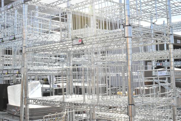 Chrome finish 6-tier wire shelving unit with contents. Buyer to dismantle. Consider freight charges. Tags visible.