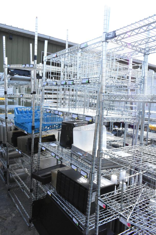 Chrome finish 4-tier wire shelving unit holding assorted metal baking pans, with visible labels. Buyer must dismantle.