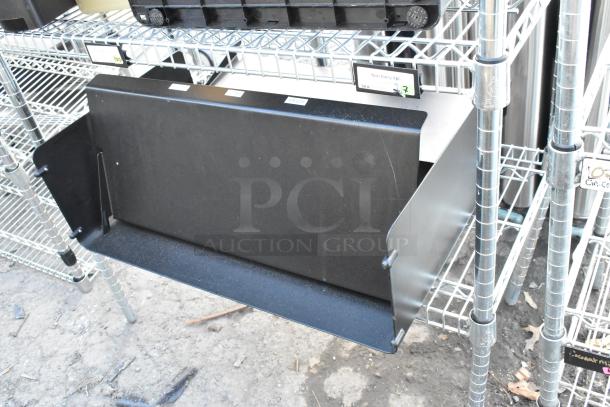 Chrome finish 4-tier wire shelving unit with metal baking pans, shown undismantled. Includes labels indicating contents.