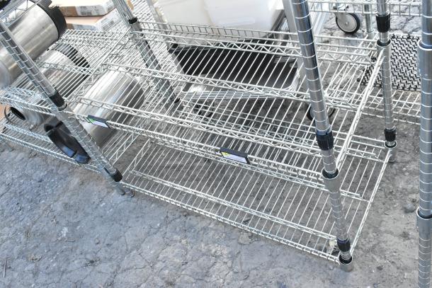 Chrome finish 6-tier wire shelving unit with poly beverage dispensers. Buyer must dismantle. Consider freight charges.