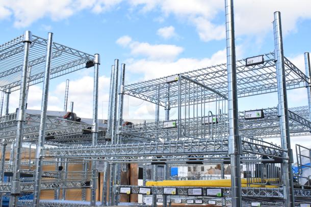 Chrome finish 6-tier wire shelving unit with contents, including WST969C divider. Buyer must dismantle. Consider freight charges.