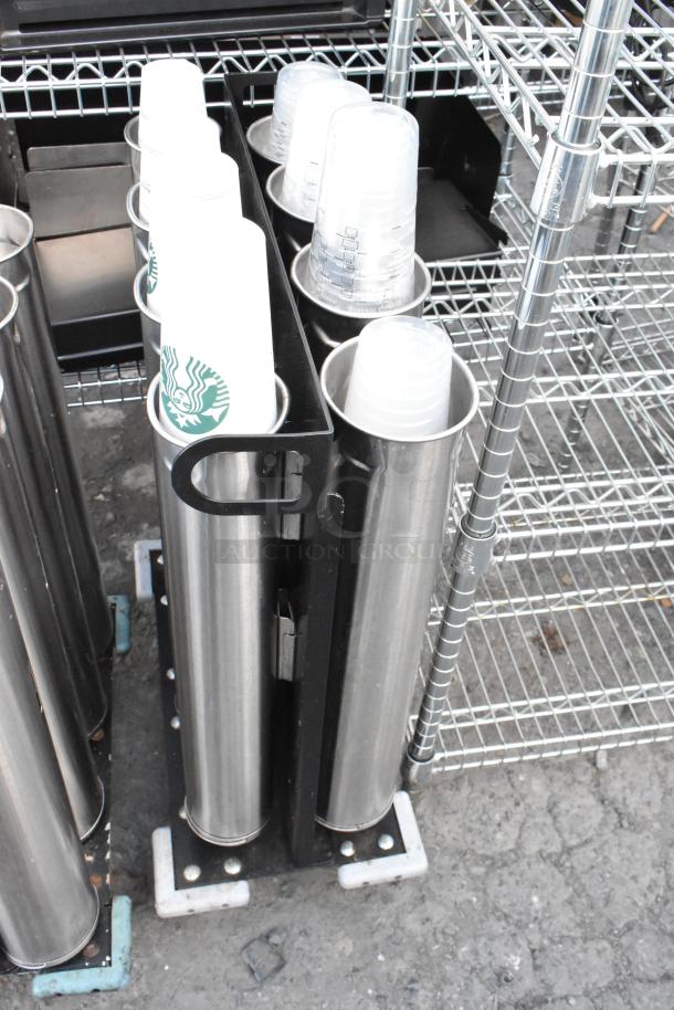 Two metal carts with eight stainless steel cup dispensers, each holding stacked disposable cups, featuring wire shelving.