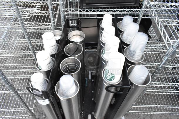 Two metal carts with eight cup dispensers each, holding assorted Starbucks cups, in good condition.