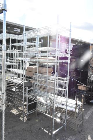 Chrome finish 4-tier wire shelving unit, sturdy design, requires dismantling for shipping, ideal for heavy-duty storage.