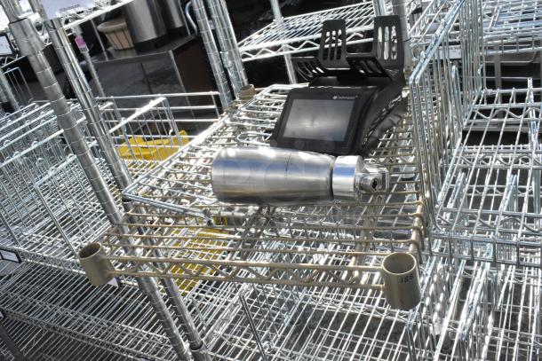 Chrome finish 6 tier wire shelving unit in good condition. Buyer must dismantle. Tags indicate freight charges applicable.