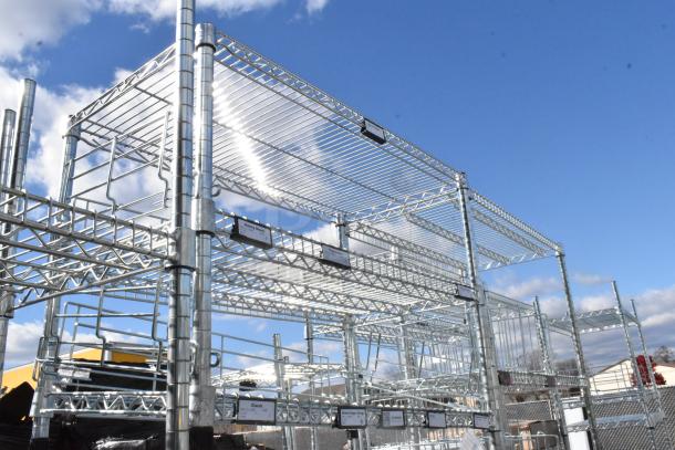 Chrome finish 5-tier wire shelving unit, outdoor setup, durable structure. Buyer must dismantle, consider freight charges.